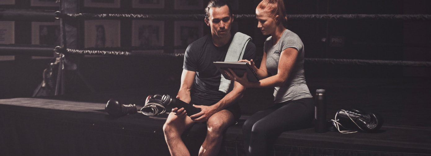 Female trainer with male client reviewing plan