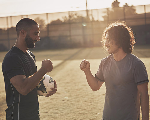 two men fist bumping