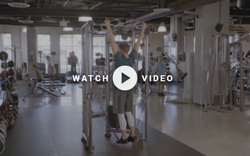 man using bands on a pull up bar