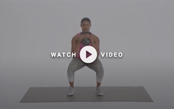 man standing with kettlebell in hands