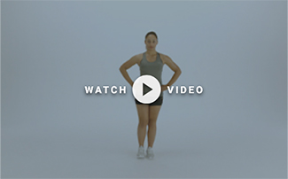 woman standing on one leg with hands on hips