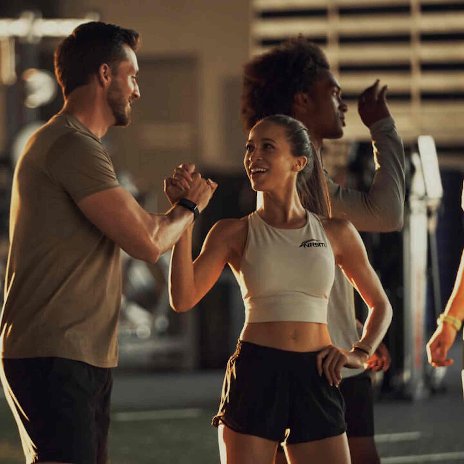 Male and female athletes shaking hands