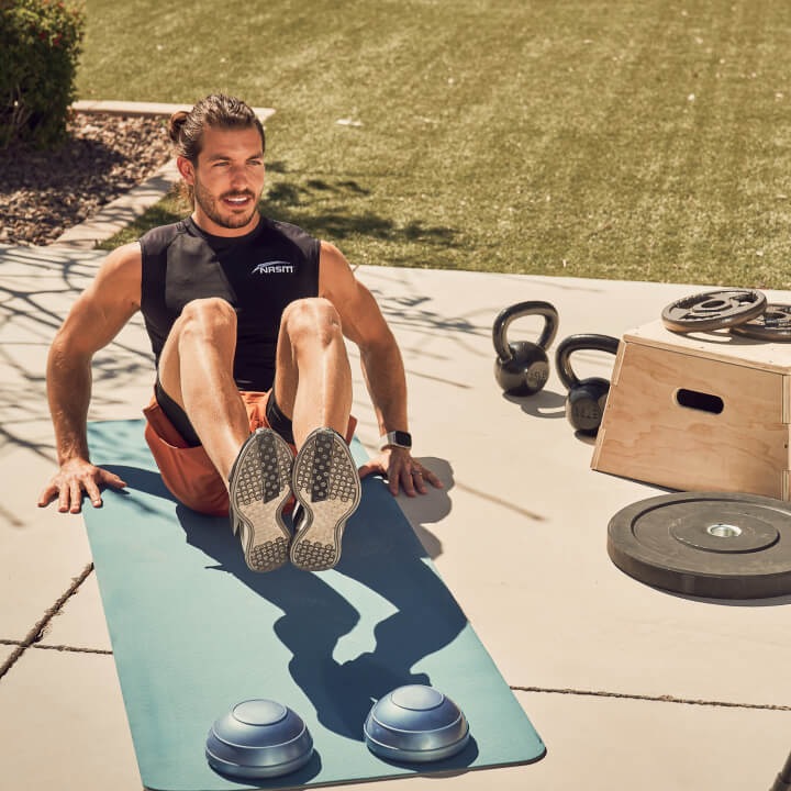 A man doing crunches outside