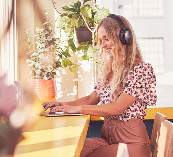 woman on her laptop with headphones