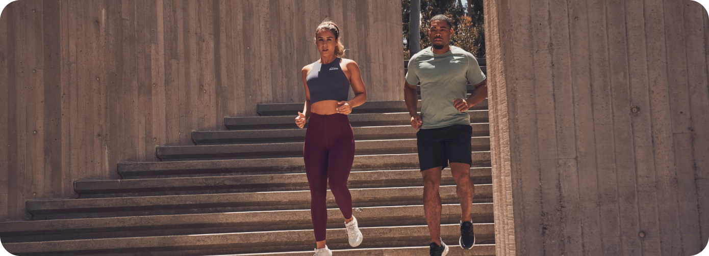 Man and Woman NASM Trainers Running Down Stairs