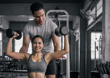 female trainer and client using the ropes