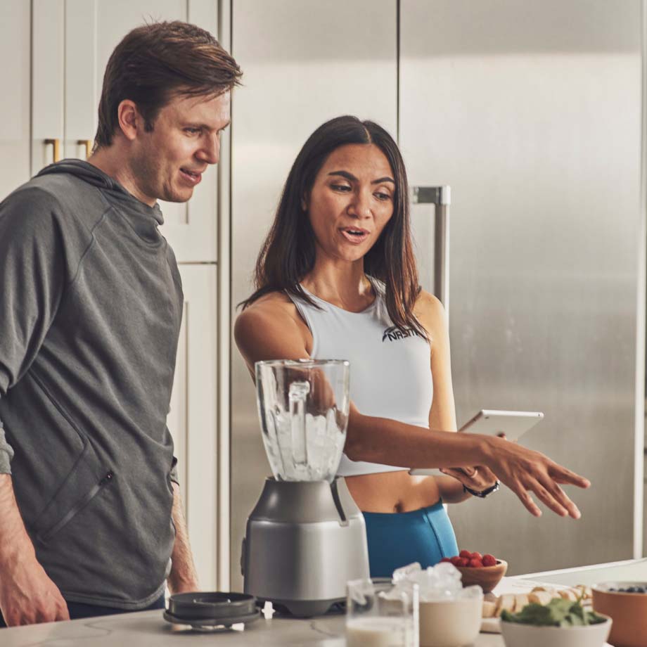 A female client showing a male client nutrition facts