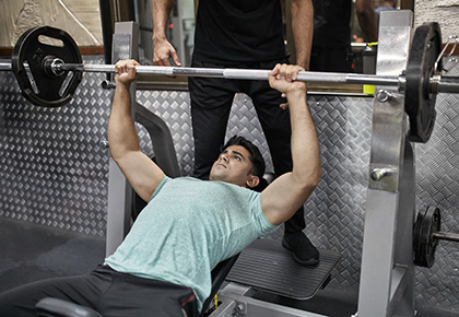 man doing maximal strength bench press set using the OPT model